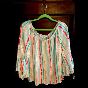 Beautiful long sleeve blouse with lace designs on sleeves.